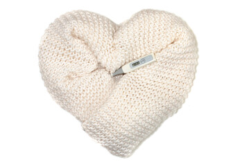 Heart made of white knitted wool and an electronic thermometer showing the temperature of a healthy person.
