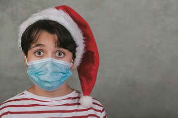 Merry Christmas, Close-up of kid with medical mask wearing Santa Claus Hat