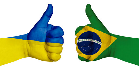 Two hands with a raised finger. They portray the gesture class, managed to negotiate. On the hands of the image of the flags of the countries, Brazil and Ukraine