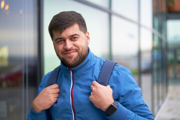 Bearded Tourist Man with backpack enjoy beautiful view of modern city