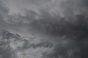 Dramatic sky with light and dark grey stormy clouds.