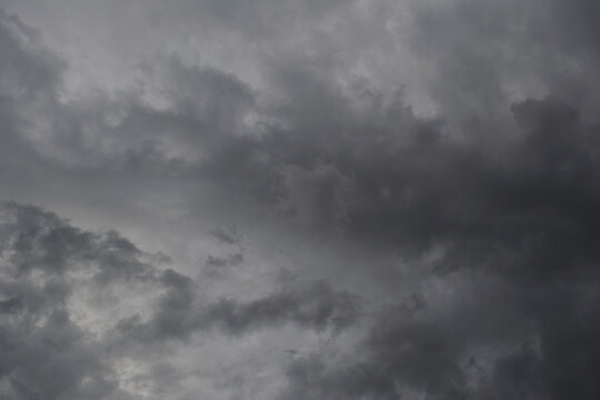 Dramatic sky with light and dark grey stormy clouds.
