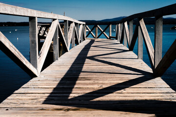 The morning sun paints geometrics patterns on a pier along the coast of Maine