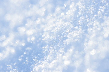 Snow close-up. Winter background with snow texture and beautiful bokeh. Shallow depth of field and blur. Perfect for Christmas and New Year design. View with copy space.