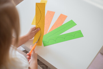 Child teaching scissors skills , cutting lines, home education concept.