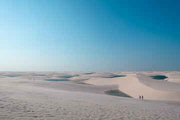 Tourists visiting natural freshwater lagoons in the dunes of Lençóis Maranhenses National Park, Maranhão - Brazil