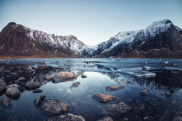 mountains over frozen lake