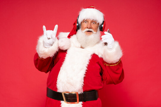 Funny bearded Santa Claus listening music.