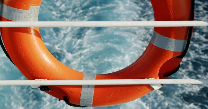 Back of ferry/boat with a life saver ring float and view of water