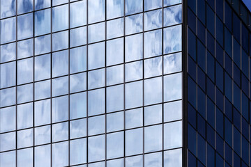 Fototapeta premium Reflex in the Skyscraper on the cloudy blue Sky