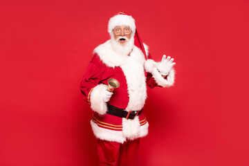 Fototapeta na wymiar Real Santa Claus posing on red studio