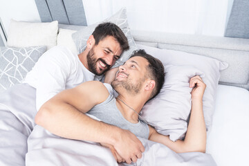 Obraz na płótnie Canvas Gay couple with locked eyes in bed