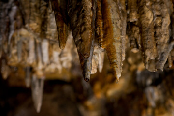 Stalactites and stalagmites inside natural limestone cave. Natural formations.