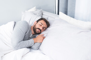 Man sleeping on bed at home
