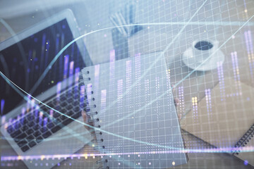 Double exposure of businesswoman hands typing on computer and forex chart hologram drawing. Financial analysis concept.