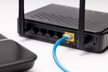 black wifi router and laptop over white background. online and network conceptual. copy space....