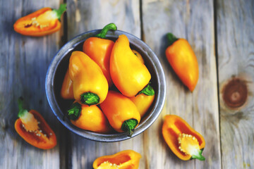 Selective focus. Yellow sweet peppers in a bowl. Autumn vegetables.
