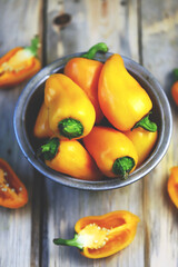 Selective focus. Yellow sweet peppers in a bowl. Autumn vegetables.