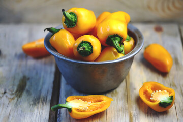 Selective focus. Yellow sweet peppers in a bowl. Autumn vegetables.