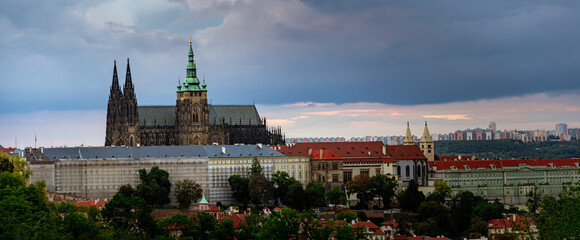 Prague Castle and St. Vitus Cathedral in the center of Prague at sunset and there are clouds in the sky in the Czech Republic