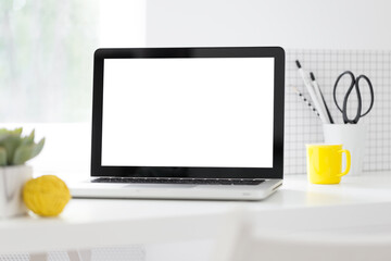 Laptop at bright office desk near window. Mockup.