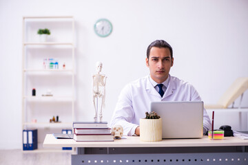 Young male doctor working in the clinic