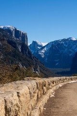 Rock Wall along Edge of Road in the Mountains at Yosemite Park with Blue Sky Background.