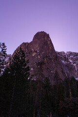 Sunrise Landscape of a Snowy Mountain at Yosemite Park with Pine Trees.