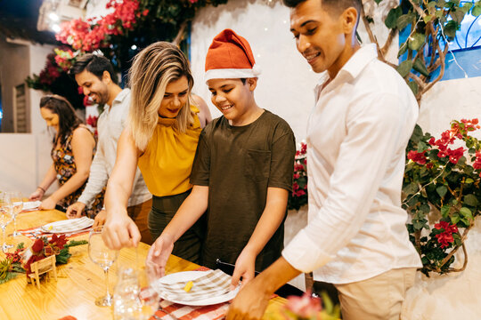 Christmas dinner in Brazil. Family and friends preparing the table in the yard for Christmas dinner.