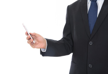 Male in formalwear standing in front of white background holding mobile phone in hand