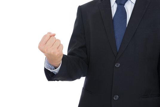 A Business Man In A Black Suit Stretches Out His Hand To Make A Fist Gesture In Front Of White Background