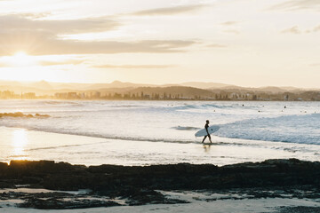 Surfer walking in at Greenmount, Queensland Gold coast