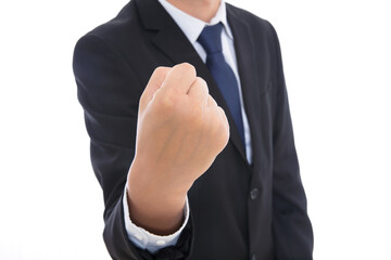 Male in black suit makes an effort gesture with his left hand fisted