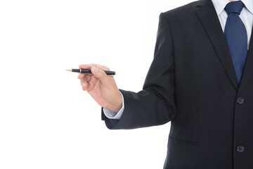 Male in a black suit holds a signature pen in his hand and points to the side