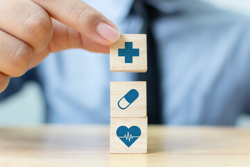 Hand arranging wood block stacking with icon healthcare medical, Insurance for your health concept