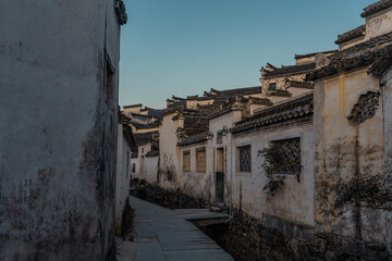 Naklejka premium Sunrise view of the streets and architectures in Xidi village, an ancient Chinese village in Anhui Province, China, a UNESCO world cultural heritage site.
