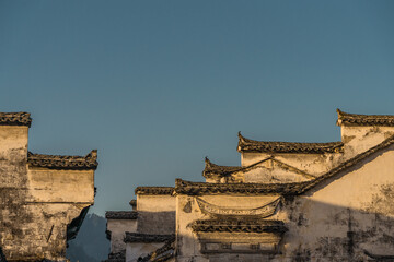 Fototapeta na wymiar Sunrise view of the architectures in Xidi village, an ancient Chinese village in Anhui Province, China, a UNESCO world cultural heritage site.