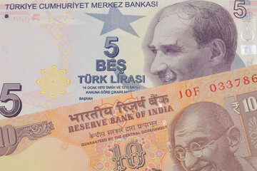 A macro image of a orange ten rupee bill from India paired up with a purple, five lira bank note from Turkey.  Shot close up in macro.