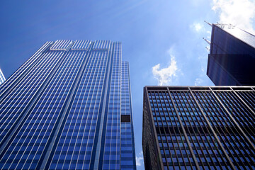 Fototapeta na wymiar Low angle shot of modern glass city buildings