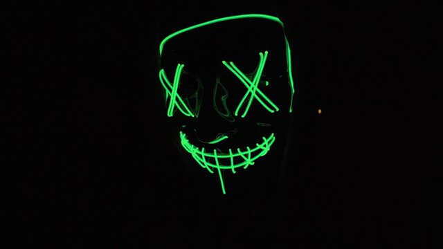 general shot traveling halloween mask with green led lights running chasing harassing killing scary dark scary the purge with red light violent night sequestration halloween party