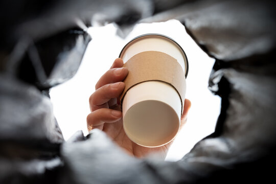 throwing a coffee cup to a rabbish bin concept of damaging the nature of using disposable things