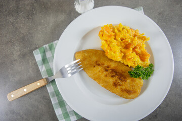 assiette de poisson pané et purée de carotte