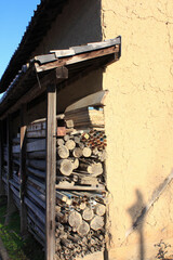 土壁の横に積まれた丸太