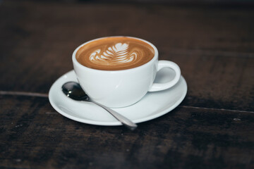 cup of coffee on wooden table in vintage style