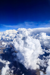 Aerial view above the clouds and mountain peaks on a sunny day.mountain view from airplane.