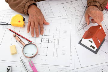 Architects compare house models to view drawings