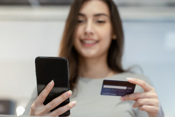 Beautiful woman smile in casual cloth using smartphone and credit card for payment. shopping online concept