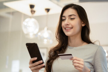 Beautiful woman smile in casual cloth using smartphone and credit card for payment. shopping online concept