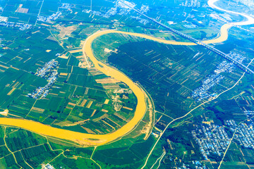 Aerial view of the green earth and winding river.