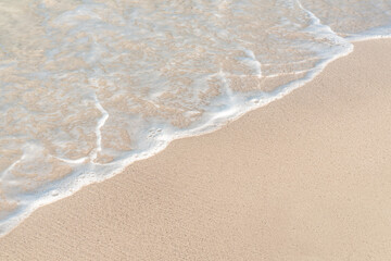Soft wave on sandy beach. Copy space